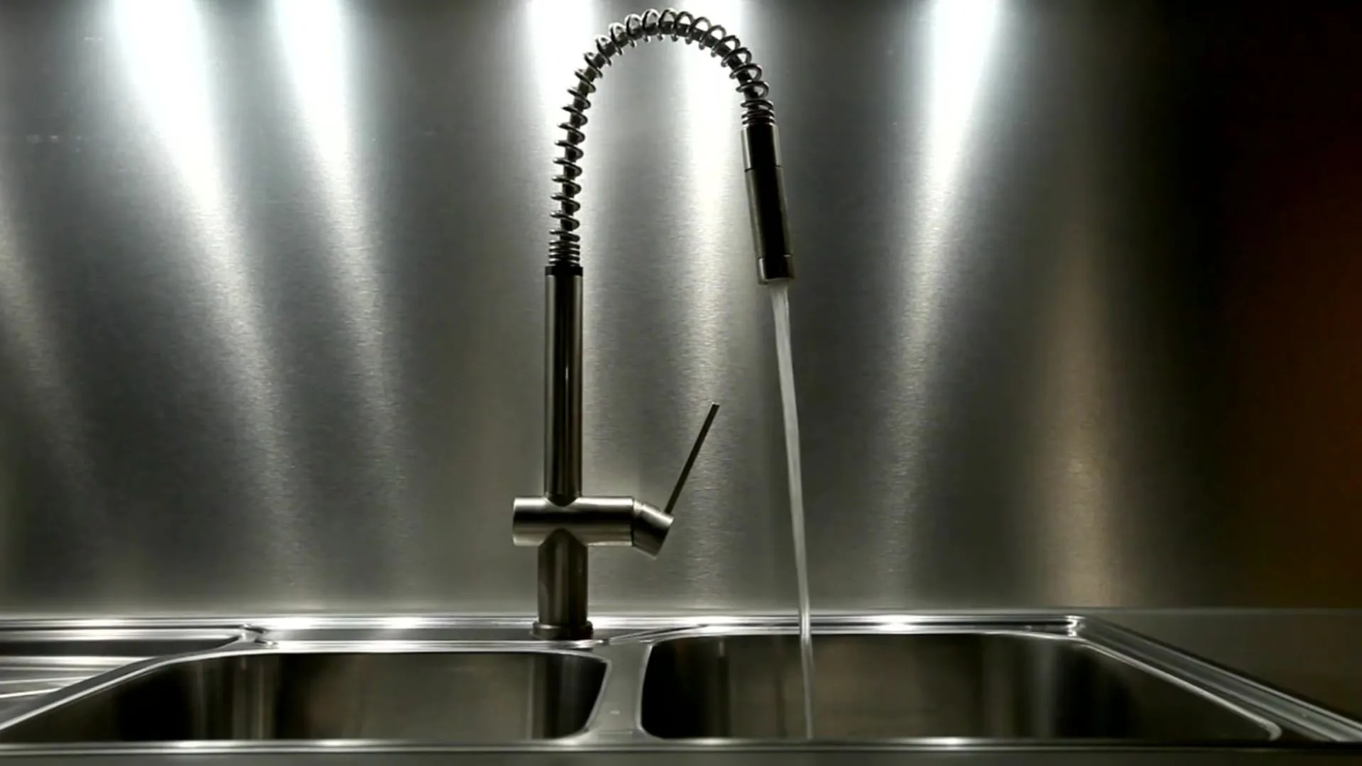 Kitchen faucet with running water — residential plumbing fixture service
