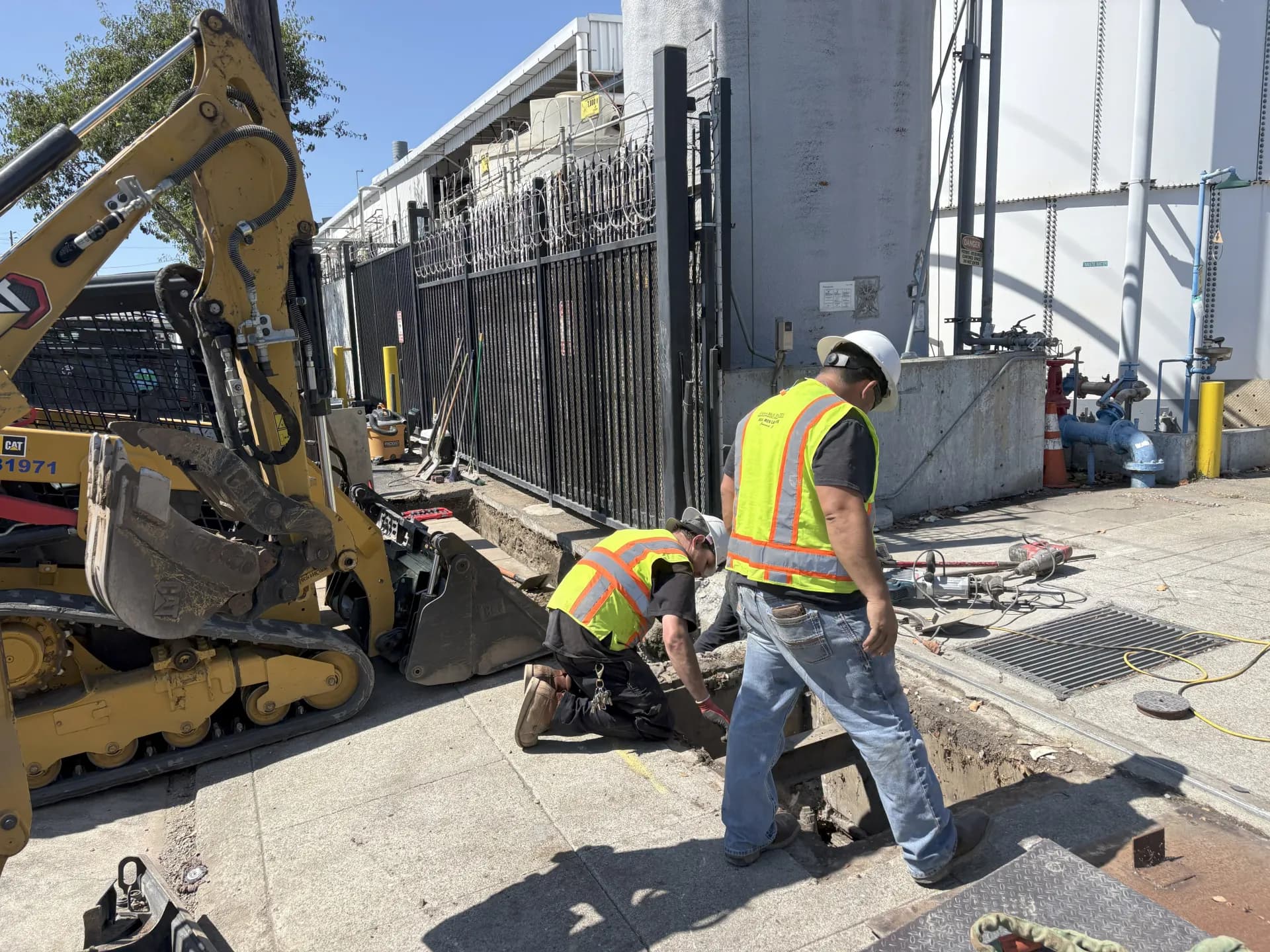 Guerra Bros. Plumbing crew with excavation equipment on a commercial job site