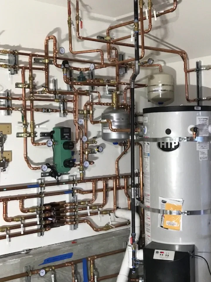 HTP water heater installed in mechanical room with copper hydronic system — Guerra Bros. Plumbing