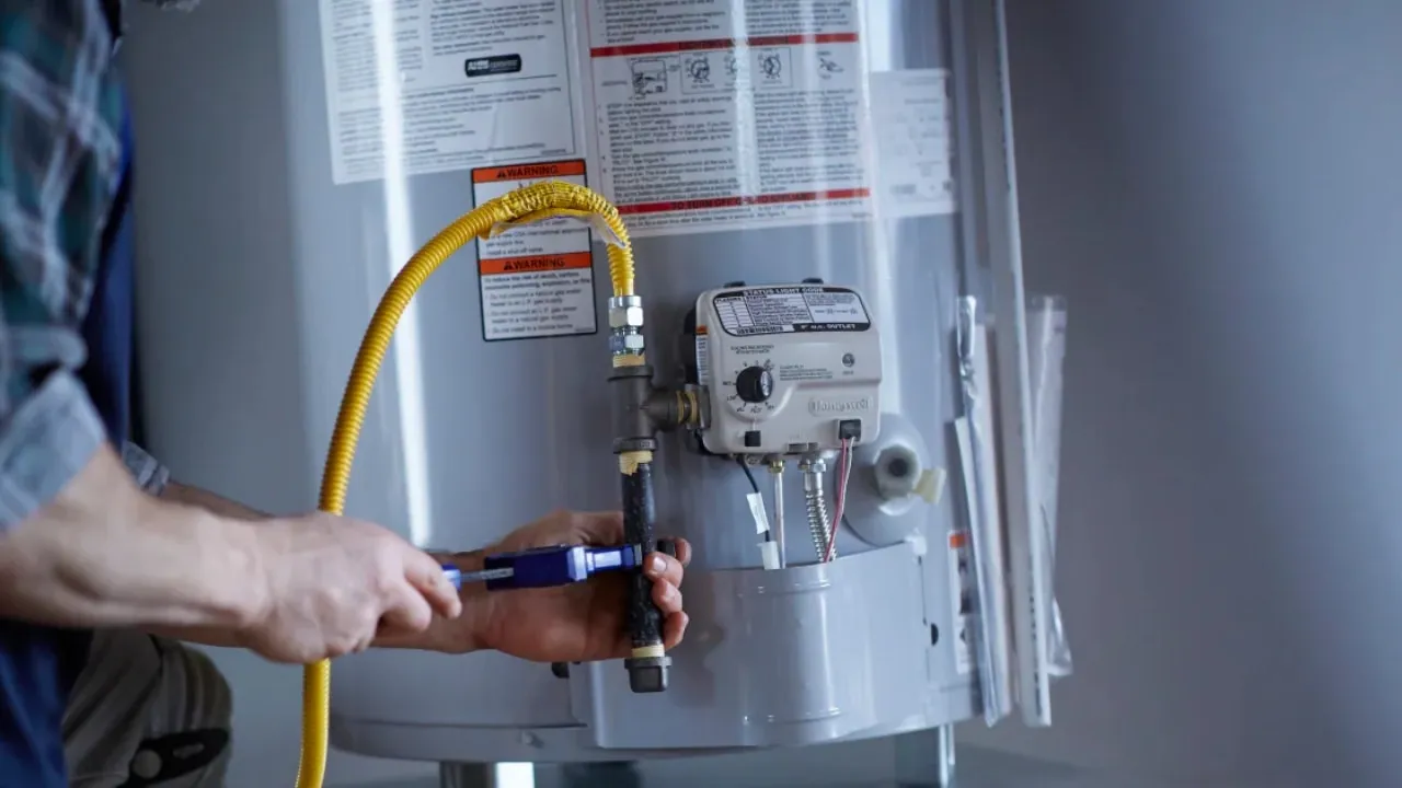 Technician repairing a residential water heater
